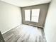 Cozy bedroom featuring hardwood floors, a neutral color scheme, and a window that offers great natural light at 10922 Snowdrop Way, Indianapolis, IN 46235