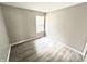 Bright bedroom with neutral walls, hardwood flooring, and a window with blinds at 10922 Snowdrop Way, Indianapolis, IN 46235