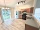 Open kitchen and dining area with stainless steel appliances and access to deck through sliding glass doors at 10922 Snowdrop Way, Indianapolis, IN 46235