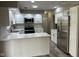 Bright kitchen with white cabinets, stainless steel appliances, and a breakfast bar with a light granite countertop at 1101 E 25Th St, Muncie, IN 47302
