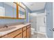 Bright bathroom with double vanity, framed mirror, and walk-in shower with a glass door at 11254 N Sashing Way, Monrovia, IN 46157