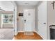 Inviting foyer area with hardwood floors, a white front door, and a welcome sign at 11254 N Sashing Way, Monrovia, IN 46157