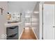 Hallway featuring hardwood floors leading to an open-concept kitchen at 11254 N Sashing Way, Monrovia, IN 46157