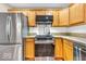 Well-lit kitchen features wood cabinets and stainless steel appliances including a LG oven and refrigerator at 11254 N Sashing Way, Monrovia, IN 46157