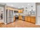 Kitchen with stainless steel appliances, wood cabinets, and hardwood floors at 11254 N Sashing Way, Monrovia, IN 46157