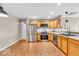 Spacious kitchen with stainless steel appliances, wood cabinets, and hardwood floors at 11254 N Sashing Way, Monrovia, IN 46157