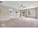 Spacious living room with ceiling fan and sliding glass door leading to the backyard at 11254 N Sashing Way, Monrovia, IN 46157