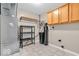 Utility room with tile flooring, storage cabinets, and essential appliances for convenience at 11254 N Sashing Way, Monrovia, IN 46157