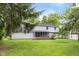 Exterior of home with a charming screened-in porch overlooking the spacious backyard and lush landscaping at 1127 Junco Dr, Columbus, IN 47203