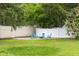 Backyard features a cozy gravel firepit area with comfortable Adirondack chairs, and privacy fence at 1127 Junco Dr, Columbus, IN 47203