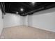 Finished basement with neutral carpet, recessed lighting, and open door leading to another room at 1127 Junco Dr, Columbus, IN 47203