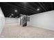 Finished basement with neutral carpet, recessed lighting, and staircase to the main level at 1127 Junco Dr, Columbus, IN 47203