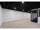 Finished basement with neutral carpet, recessed lighting, and a staircase leading to the main level at 1127 Junco Dr, Columbus, IN 47203
