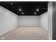 Spacious finished basement featuring neutral carpet, recessed lighting, and freshly painted white walls at 1127 Junco Dr, Columbus, IN 47203