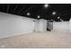 Finished basement featuring neutral carpet, recessed lighting, and stairs leading to main level at 1127 Junco Dr, Columbus, IN 47203