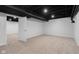 Finished basement with neutral carpet, recessed lighting, and an open door to another room at 1127 Junco Dr, Columbus, IN 47203
