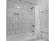 Bathtub with white tiling and a built-in shelf, complemented by a shower curtain at 1127 Junco Dr, Columbus, IN 47203