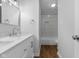 Modern bathroom featuring a double sink vanity with white marble countertop and tiled shower at 1127 Junco Dr, Columbus, IN 47203