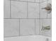 Close up of tiled bathtub with silver water knobs at 1127 Junco Dr, Columbus, IN 47203