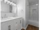 Bright bathroom featuring a double sink vanity with white countertop and tiled shower at 1127 Junco Dr, Columbus, IN 47203
