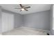 Bedroom with neutral carpet, gray walls, and a ceiling fan with light at 1127 Junco Dr, Columbus, IN 47203