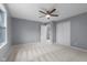 Bedroom with neutral carpet, gray walls, closet, and a ceiling fan with light at 1127 Junco Dr, Columbus, IN 47203