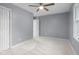 Bedroom with neutral carpet, gray walls, and a ceiling fan with light at 1127 Junco Dr, Columbus, IN 47203