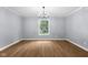 Bright dining room featuring hardwood floors, modern lighting, and a large window offering natural light at 1127 Junco Dr, Columbus, IN 47203