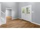 Bright foyer with light-gray walls, wood-look flooring, and a glass paneled front door at 1127 Junco Dr, Columbus, IN 47203