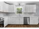 Beautiful eat-in kitchen with stainless appliances, bright white cabinets, and under cabinet lighting at 1127 Junco Dr, Columbus, IN 47203