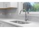 The kitchen features a double sink basin and a high arc faucet under a bright window at 1127 Junco Dr, Columbus, IN 47203