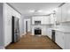 Beautiful kitchen features stainless appliances, white cabinets, subway tile backsplash, and wood-look flooring at 1127 Junco Dr, Columbus, IN 47203