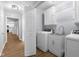 Well-organized laundry room equipped with washer, dryer, sink, and ample cabinet space at 1127 Junco Dr, Columbus, IN 47203