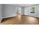 Open-concept living room with hardwood floors and neutral paint, providing a flexible living space at 1127 Junco Dr, Columbus, IN 47203