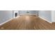 Living room with wood-look flooring, neutral walls, a window, and a fireplace with white mantel at 1127 Junco Dr, Columbus, IN 47203