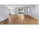 Bright living room featuring luxury wood-look flooring and slider access to screened porch at 1127 Junco Dr, Columbus, IN 47203