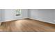 Bright, open living room featuring beautiful hardwood floors and a large window at 1127 Junco Dr, Columbus, IN 47203