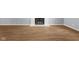 Living room with wood-look flooring and a fireplace featuring a painted-brick surround at 1127 Junco Dr, Columbus, IN 47203