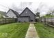 Fenced backyard with green grass, deck, and siding at 1201 Villa Ave, Indianapolis, IN 46203