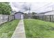 Fenced backyard with green grass, garage and stone paver walkway at 1201 Villa Ave, Indianapolis, IN 46203
