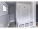 Bright and modern entryway featuring a custom bench with storage at 1201 Villa Ave, Indianapolis, IN 46203