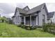 Inviting two-story home with a well-manicured lawn and cozy front porch at 1201 Villa Ave, Indianapolis, IN 46203