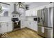 Modern kitchen features stainless steel appliances, white cabinets, and light hardwood floors at 1201 Villa Ave, Indianapolis, IN 46203