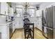 Modern kitchen with white cabinets, stainless steel appliances, and a breakfast bar at 1201 Villa Ave, Indianapolis, IN 46203