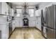 Modern kitchen with stainless steel appliances, white cabinets, subway tile and hardwood floors at 1201 Villa Ave, Indianapolis, IN 46203