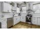 Bright kitchen features modern stainless steel appliances, white cabinets, and stylish hardwood floors at 1201 Villa Ave, Indianapolis, IN 46203