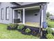 Relaxing front porch with a wood deck, stylish landscaping, and comfortable outdoor seating at 1201 Villa Ave, Indianapolis, IN 46203