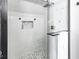 Modern tiled shower with glass door, black hardware, and hexagon tile floor is a luxurious space at 1201 Villa Ave, Indianapolis, IN 46203