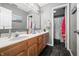 Well-lit bathroom featuring a double sink vanity, modern mirrors, and dark tile flooring at 1245 Elm Grove Ln, Greenwood, IN 46143