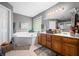 Bathroom featuring a soaking tub, custom cabinets, and updated vanity lighting at 1245 Elm Grove Ln, Greenwood, IN 46143
